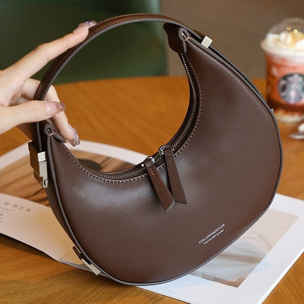 2025 spring and summer new Korean niche cowhide crescent bag, underarm bag, semi-round moon bag, shoulder handheld women's bag new