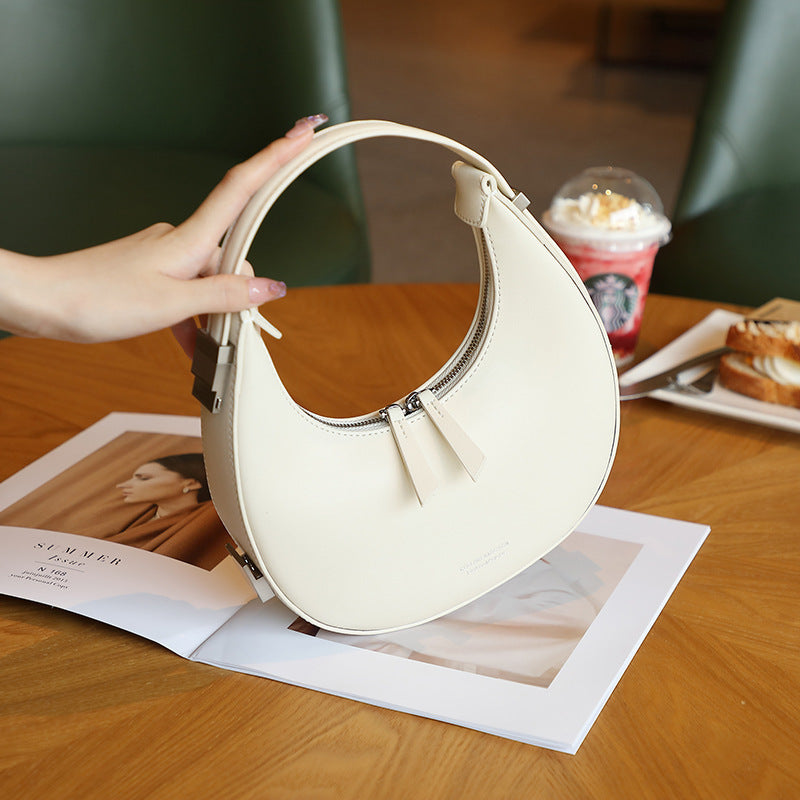 2025 spring and summer new Korean niche cowhide crescent bag, underarm bag, semi-round moon bag, shoulder handheld women's bag new