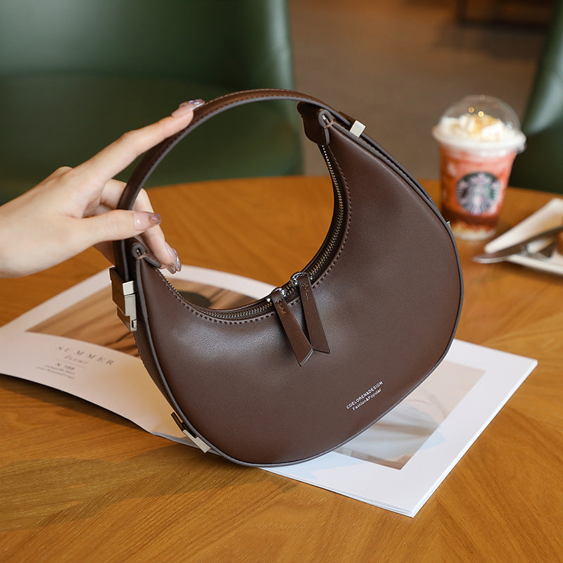 2025 spring and summer new Korean niche cowhide crescent bag, underarm bag, semi-round moon bag, shoulder handheld women's bag new