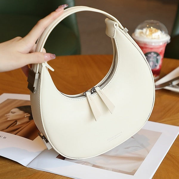 2025 spring and summer new Korean niche cowhide crescent bag, underarm bag, semi-round moon bag, shoulder handheld women's bag new
